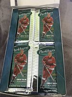 Packaged Parkhurst hockey card packs in box, each labeled with '6 cards per pack' and showing a hockey player in red uniform.