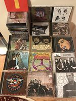 Photo of multiple CDs laid out showing artwork including Led Zeppelin, Grateful Dead, Bachman Cummings, Janis Joplin, and others.