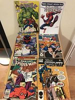 Photo showing the six Spider-Man comics arranged on a chair.
