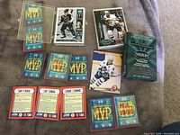 Photo showing multiple MVP hologram baseball cards, park skyline card backs featuring Stan Musial, Lou Gehrig, and Roger Clemens, McDonald's hockey cards, the Parkhurst 1992-93 Stanley Cup Update Set pack, and a hockey card featuring Doug Gilmour.