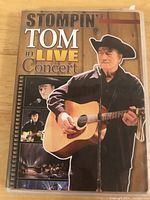 Front cover of DVD case titled 'Stompin Tom in Live Concert' with image of Stompin Tom Connors playing guitar.