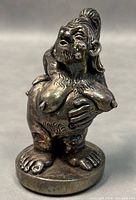 Front angle view of the 4-inch vintage 925 silver weighted sculpture showing the humanoid figure with detailed facial features, hair, and hand on chest.