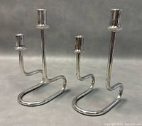 Front view of the pair of silver plated modernist Italian Maestri candleholders with minor wear.