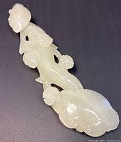 Overall front view of jade ruyi scepter showing head, stem and fungus motifs