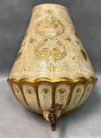 Front and side view of vintage Florentine ceramic wall pocket with brass water tap, showing detailed gold scroll and floral decorations and scalloped base.