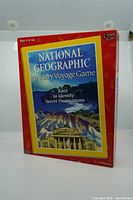 Front view of the National Geographic Mystery Voyage board game box showing age recommendation, player number, and game title.