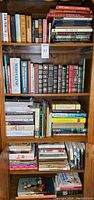 Full bookshelf showing a variety of books including medical, cookbooks, wellness and decorative topics.