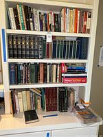 Full bookshelf showing assorted hardback books including vintage and reference books