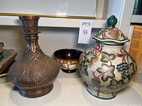 Photo showing copper vase, mosaic bowl, and clay urn with lid with grapevine pattern and internal crazing