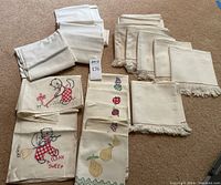 Full view of all folded and stacked towels in groups showing variety of themes and plain towels