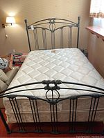 Front view of metal bed frame with mattress installed in bedroom