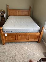 Front view of assembled pine wood bed frame with mattress