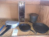 All items in original lot grouped on wood-patterned floor including boxes and vacuum container.