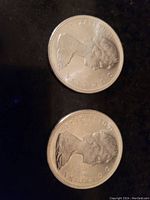 Obverse side of two Canadian silver dollar coins showing Queen Elizabeth II