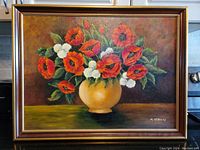 Frontal view of the framed original oil painting showing the bouquet of red and white flowers in a yellow vase signed by M. Stevens.