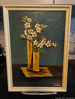 Full front view of the framed original oil painting by M.Stevens showing white flowers in yellow vases on a mat.