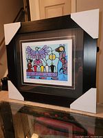 Framed art print featuring Thunderbird image by Norval Morrisseau with protective corner covers on frame.