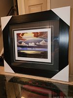 Framed fine art print by Lawren Harris, visible title and signature, black modern frame with corner protectors.