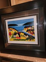 Full front view of framed print showing artwork, matting, and black frame