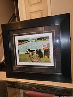 Framed print shown from an angle displaying the entire artwork and frame.