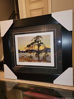 Front view of the professionally framed Tom Thomson fine art print titled 'Jack Pine' with packaging corners on frame, showing the artwork and matting clearly.