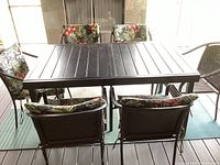 Full view of table with six chairs and five cushions