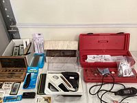 Overview image showing the tap and die set wooden box, X-ACTO knives, soldering iron, and other small tools in packaging and loose.