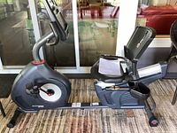 Right side view of grey Schwinn 270 recumbent bike showing frame, seat, and flywheel casing