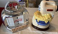 Silver Coca-Cola tabletop jukebox cookie jar with visible brand and detail of coin slot