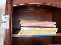 Shelf with a stack of children's board and paperback books including vintage and newer titles.