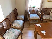 Five chairs arranged around dining table