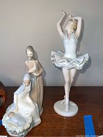 Photo showing three porcelain figurines: Rosenthal ballerina and LLadro nativity figures of Mary, Joseph, and infant Jesus.