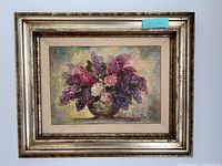 Image of the entire framed painting showing the floral bouquet and frame.