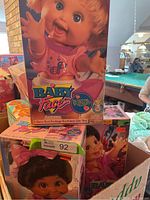 Three boxed Baby Face dolls displayed together