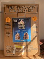 Box front showing The Tennyson Dollhouse Kit with model images and features listed.