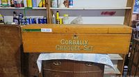 Front view of vintage wooden croquet box labeled 'The Corbally Croquet Set'. The box is closed, showing the main branding.