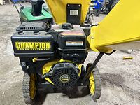 Front view showing engine, recoil starter, and wheels