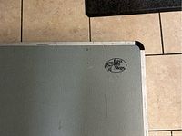 Top of the closed camp kitchen showing Bass Pro Shops logo on gray textured surface.