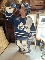 Front view of Curtis Joseph cardboard cutout in Toronto Maple Leafs gear with details of equipment and water bottle.