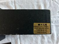 Close-up of the black box with gold label indicating 23 KT gold plated and made in Spain.