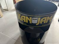 Photo of cylindrical Kan Jam game goal showing original logo and branding