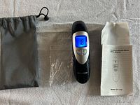 Full kit including Keto Breathalyzer Meter with digital display reading 18, mouthpieces, gray drawstring pouch, and user manual.