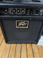 Front view of Peavey Max 158 bass amplifier showing control panel with knobs and Peavey Bass Systems logo on speaker grille.