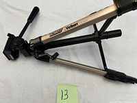 Side view of Velbon camera tripod showing the foldable leg and pan-tilt handle.