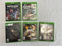 Top view showing five Xbox games Watch Dogs Legion, Generation Alpha, The Callisto Protocol Day One Edition, Call of Duty Black Ops III, Tom Clancy's The Division 2