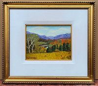 Frontal view of the vintage signed oil painting in gold frame with white mat and inner gold liner showing Canadian landscape scene with trees, river, and mountains.