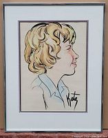 Framed watercolor and ink portrait painting showing side profile of a person with curly blonde hair, signed Katz.