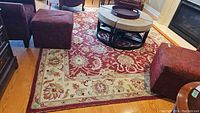 Full view of synthetic area rug placed in living room under coffee table and surrounding furniture.