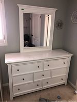 Full front view of white dresser with mirror showing overall condition and style