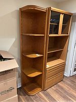 Full view of wood corner shelving unit with multiple shelves and natural wood finish.